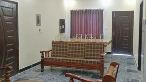 A room with a sofa set, a dining table, and a ceiling fan. - Ideal Holiday Destination for Families (Murree)