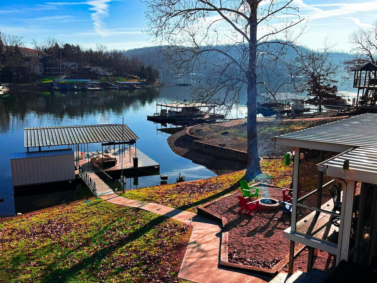 A lakeside property with a dock, a gazebo, and a well-maintained garden.