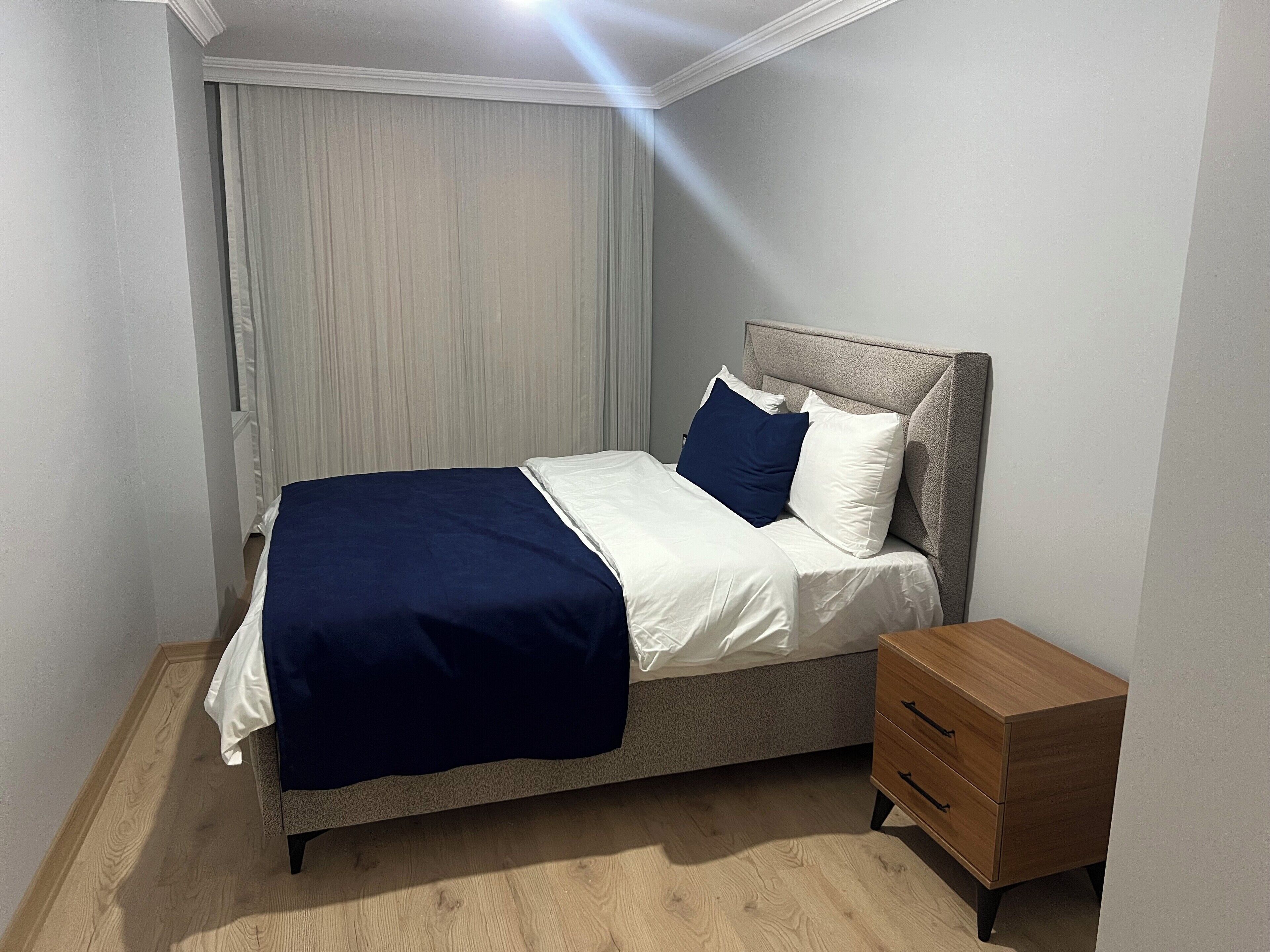 Premium bedding, laptop workspace, iron/ironing board, bed sheets