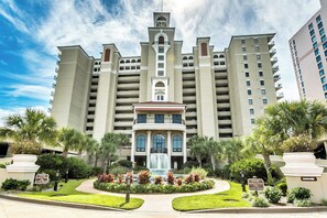 A large hotel with a central fountain, multiple balconies, and lush landscaping. - Perfect Oceanfront One Bedroom Condo Southwind 204 (Myrtle Beach)