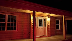 A wooden cabin with a porch, a front door, and two windows. - Adorable New 2-bedroom lake house in West Newfields, with Lake access. (West Newfields)