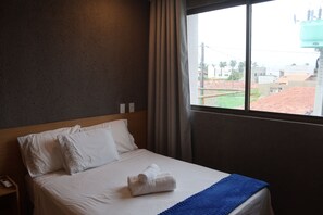 A hotel room with a bed, a window, and a view of the outside. - MHV Milagres - Manah B 212 &  B 211  (São Miguel dos Milagres)