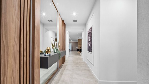 A modern hallway with a wooden panel wall, a reception desk, and a framed artwork on the wall. - 9BR house sleeps 20 with spa in kissimmee (Kissimmee)