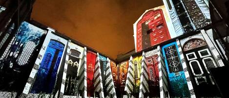 A series of illuminated building facades with various architectural designs.