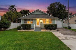 A single-story house with a front porch, a garage, and a well-maintained lawn. - 3BR Dog Friendly Home- Crescent Beach- Blue Haven (North Myrtle Beach)