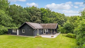 A two-story house with a dark exterior, a front porch, and a small garden area. - "Matias" - 30km from the sea by Interhome (Toftlund)