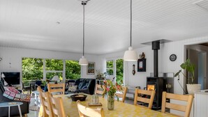 A spacious living area with a dining table, chairs, a sofa, and a television. - "Matias" - 30km from the sea by Interhome (Toftlund)
