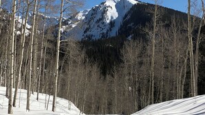 A snow-covered road with tire tracks leading towards a mountain. - Sheraton Mountain Vista Villa, Avon Colorado, 2-BR, easy access to Beaver Creek (Avon)