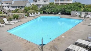A rectangular swimming pool with a 3 FT depth marking, surrounded by lounge chairs and a wooden deck. - This one's for David 3 bed 2.5 bath home with POOL (North Topsail Beach)