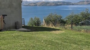 A house with a view of a lake and mountains.