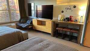A hotel room with two beds, a TV, a desk with a coffee machine, and a wall decal that says "Coffee Bar". - Ski-In + Out XL Studio. Expedition Station in Village. Mtn Views. 2 Queen Beds. (Snowshoe)