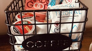 A black wire basket containing various coffee products and a 'Made Good' bag. - Ski-In + Out XL Studio. Expedition Station in Village. Mtn Views. 2 Queen Beds. (Snowshoe)