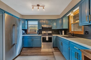 Fridge, microwave, oven, stovetop - Spacious 6-bedroom lake home with an indoor pool, hot tub, and sauna. (Willmar)