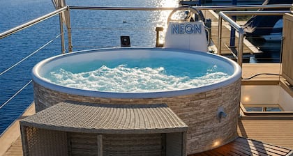 Neon House Boat—Luxury Stay on Lake Maggiore with a Hot Tub