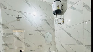 A bathroom with a white sink, a toilet, and a shower with a white wall-mounted heater. - Hotel Brothers  (Dera Bassi)