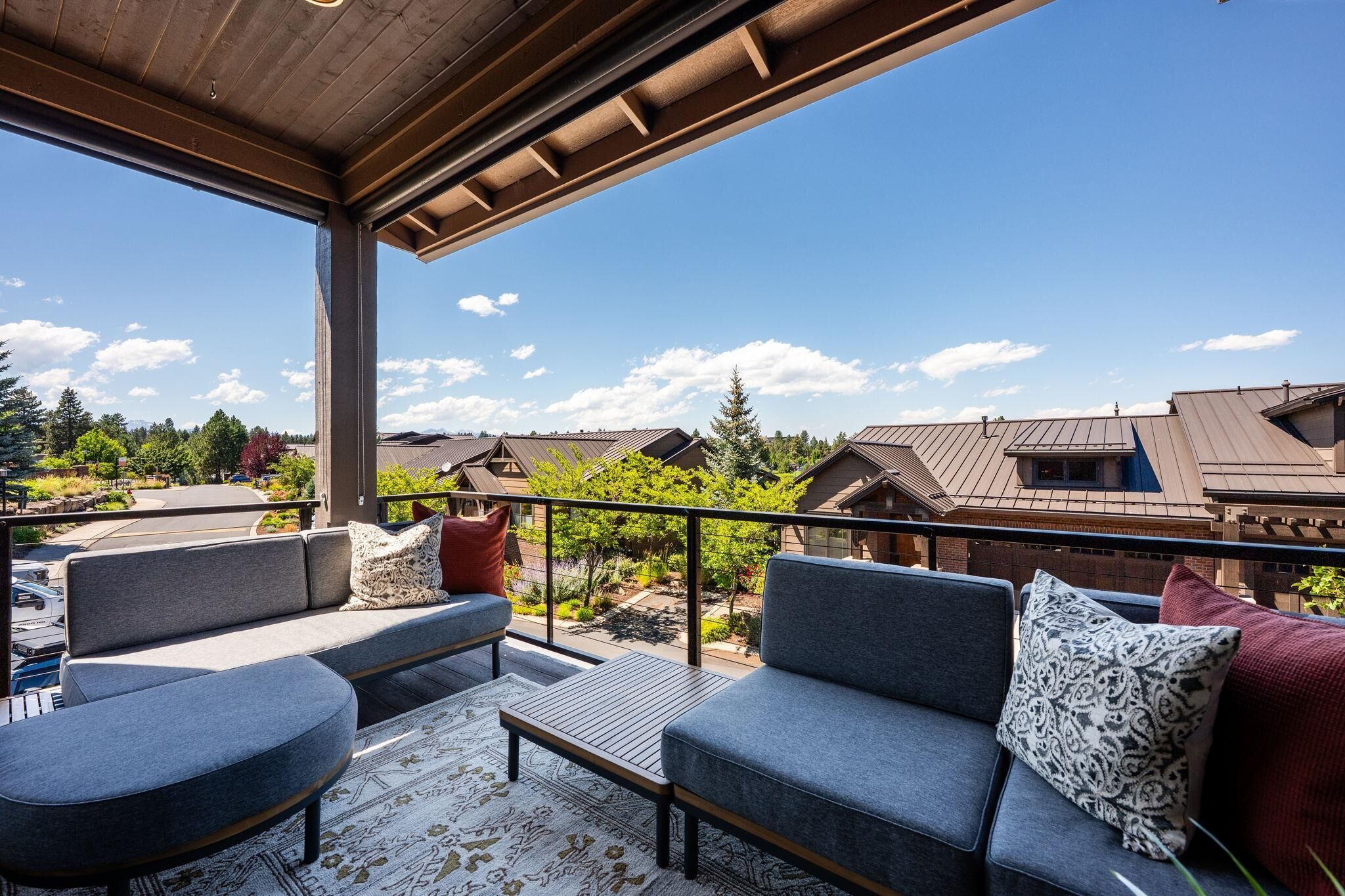 An outdoor seating area with a view of residential buildings and trees.
