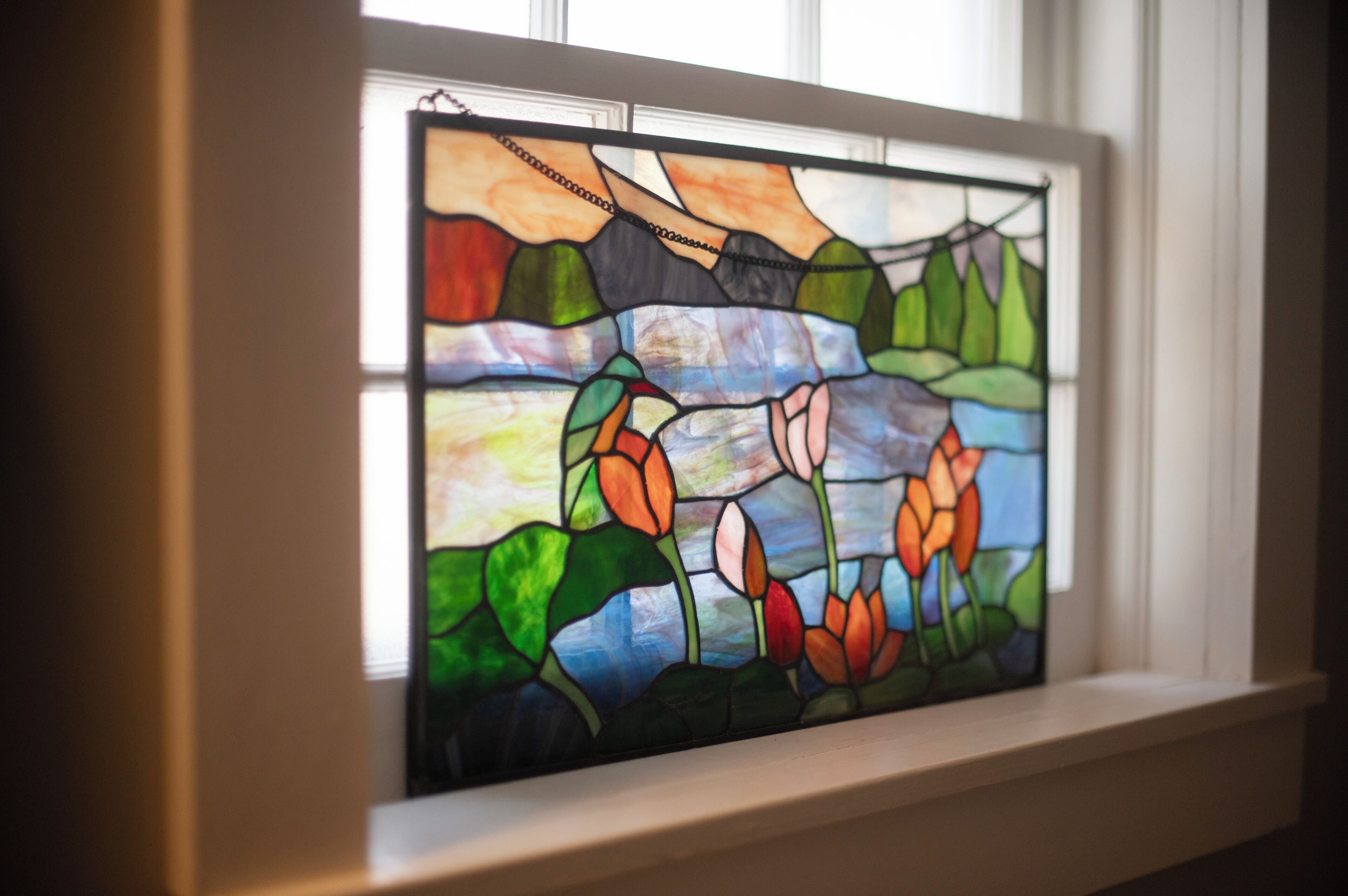 A stained glass window with floral patterns.