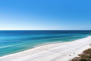 A beach with clear blue water and a white sandy shore. - Endless Beach Front Views Await – Long Beach Resort Escape W/Free Beach Chairs (Panama City Beach)