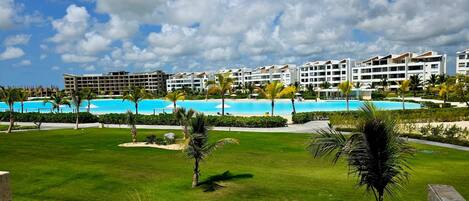 A resort with multiple buildings, a swimming pool, and well-maintained lawns.