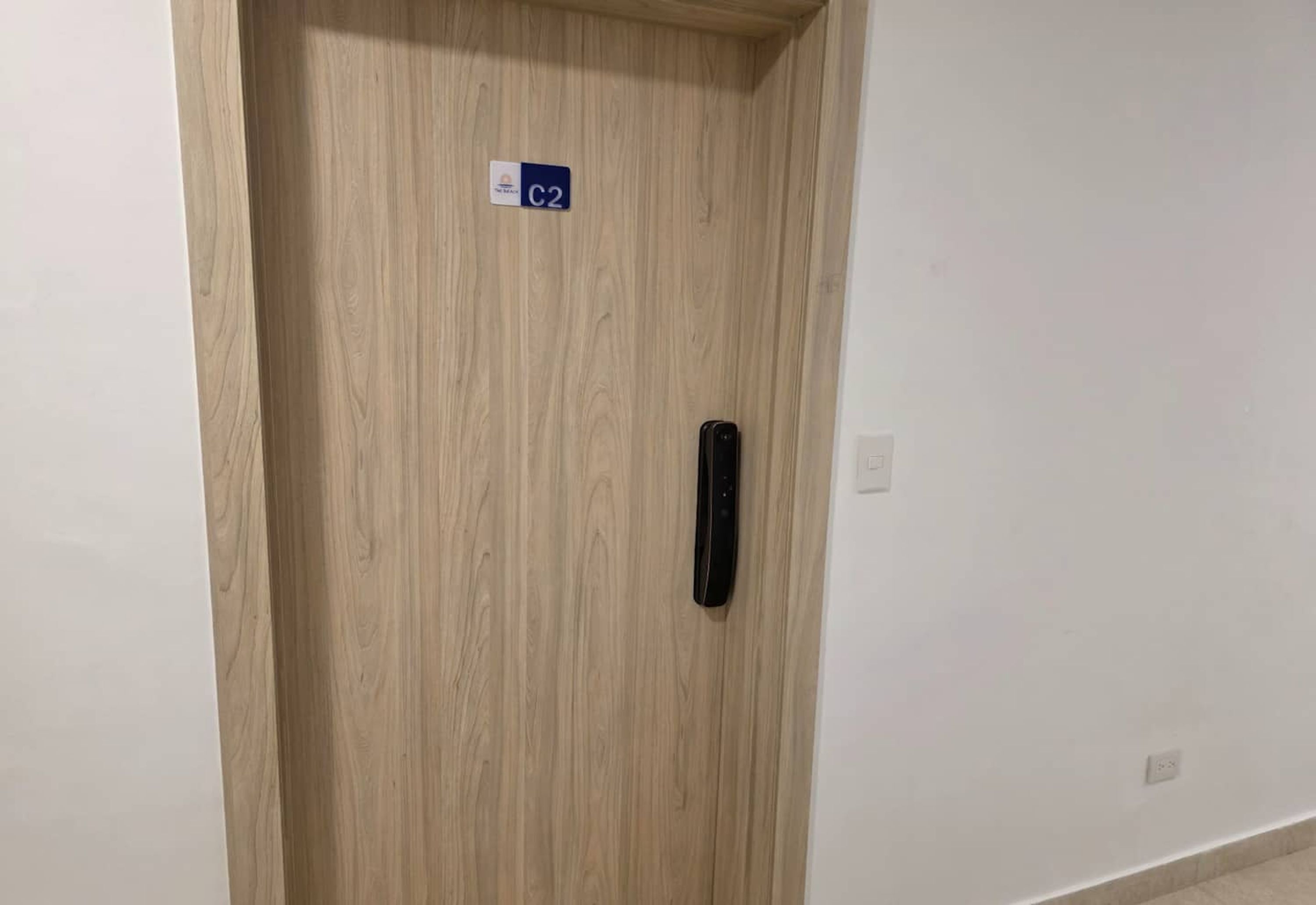 A wooden door with a sign indicating room C2.