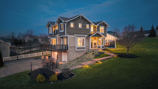 A multi-story house with a covered porch, a driveway, and a well-maintained lawn. - Lion’s Lookout | PSU Retreat w/Hot Tub & Game Room (Bellefonte)