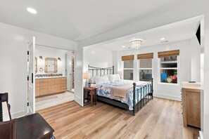 A bedroom with a bed, bedside tables, a window with blinds, and a view of the outside. - Waterfront Bay Views, Private Pool, 6 Bedroom, Pet-Friendly! Sleeps14 (Virginia Beach)