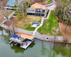 A lakeside property with a dock, a covered deck, and a swimming pool. - Copper Cove! Hot Tub, 5 Kings & 6 Bunks. FirePit-Sunroom-Sundeck-kayaks-SUP-Fish (Bracey)