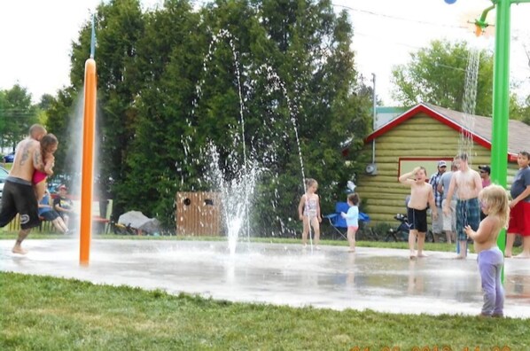 A group of people playing with water jets in a park. - Magnificent Ancestral dwelling (Scotstown)