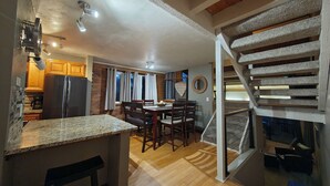 A kitchen with wooden cabinets, a granite countertop, and a built-in refrigerator. - Chilling in the Boat! Location, Comfort & Style (Steamboat Springs)