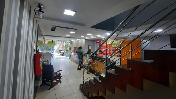 A modern interior with a staircase, a fire extinguisher, and a vending machine. - HOTEL BELCENTRO (Belém)