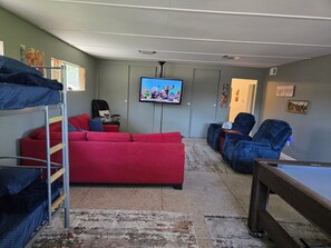 TV, fireplace - Charming 2-bedroom farm bunkhouse with hiking, pool/hot tub & petting zoo (Crosby)