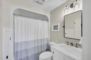 Shower, hair dryer, towels, toilet paper
