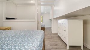 A bedroom with a bed, a dresser, and a wardrobe. - Enjoyable 4 Bedroom on M22 - Close to Traverse City & Suttons Bay (Traverse City)