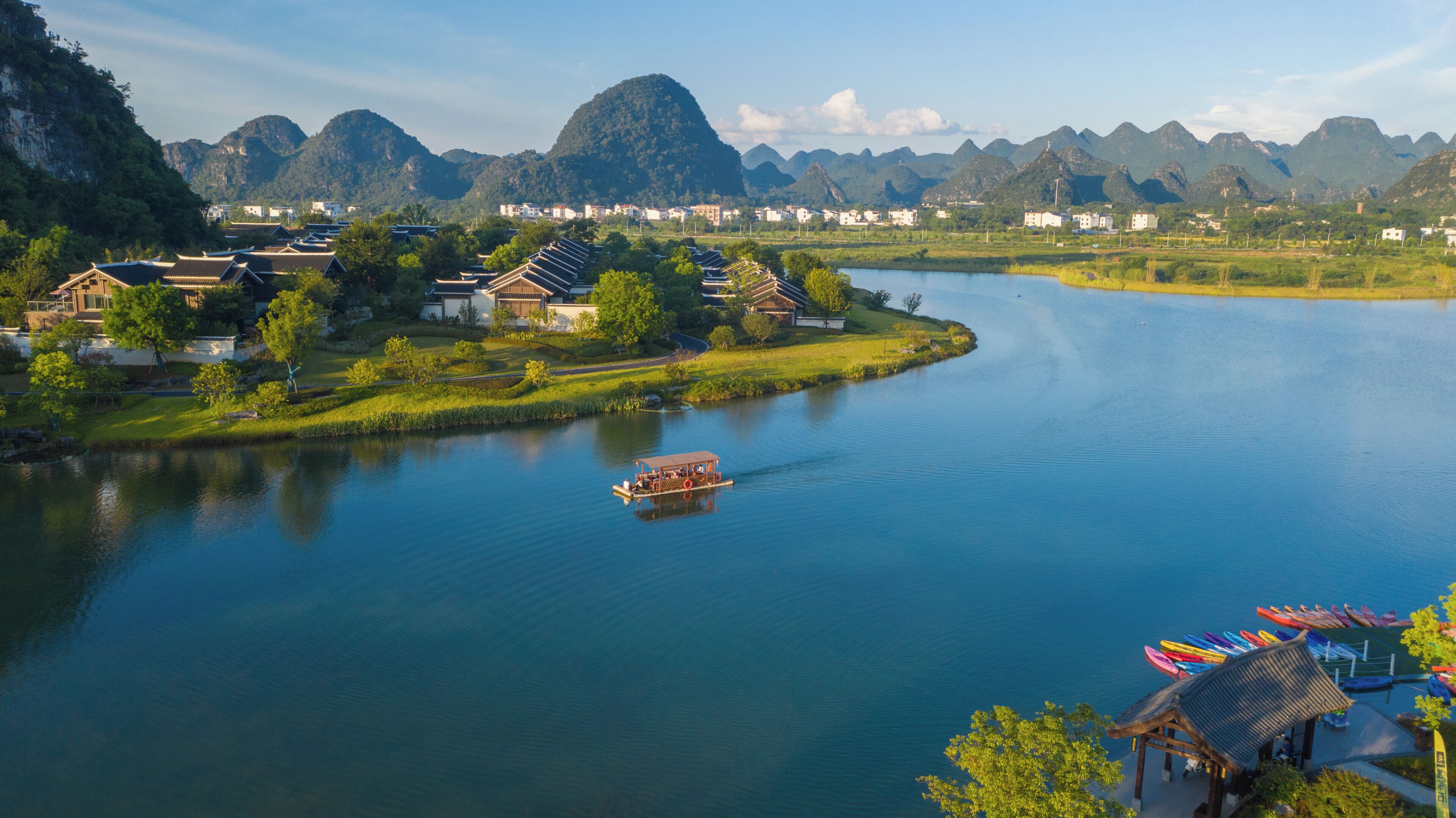 A river with traditional houses and a boat.