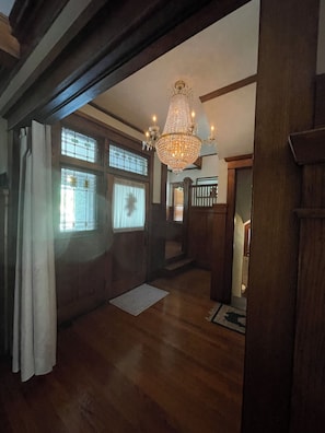 A wooden interior with a chandelier, wooden floors, and a staircase. - Welcoming 4-bedroom house with steam heat and gas fireplace in charming Danville (Danville)