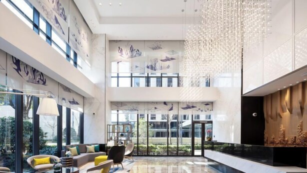 A spacious lobby with a high ceiling, modern furniture, and a large chandelier. - The Hotel V Hongqiao  (Shanghai)