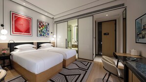 A modern hotel room with two beds, a desk, a chair, and artwork on the walls. - The Hotel V Hongqiao  (Shanghai)