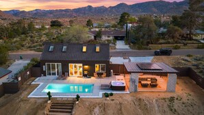 A modern house with a swimming pool, outdoor seating, and a hot tub. - NEW: Sol + Shadow | Pool | Spa | Walk to Downtown (Joshua Tree)