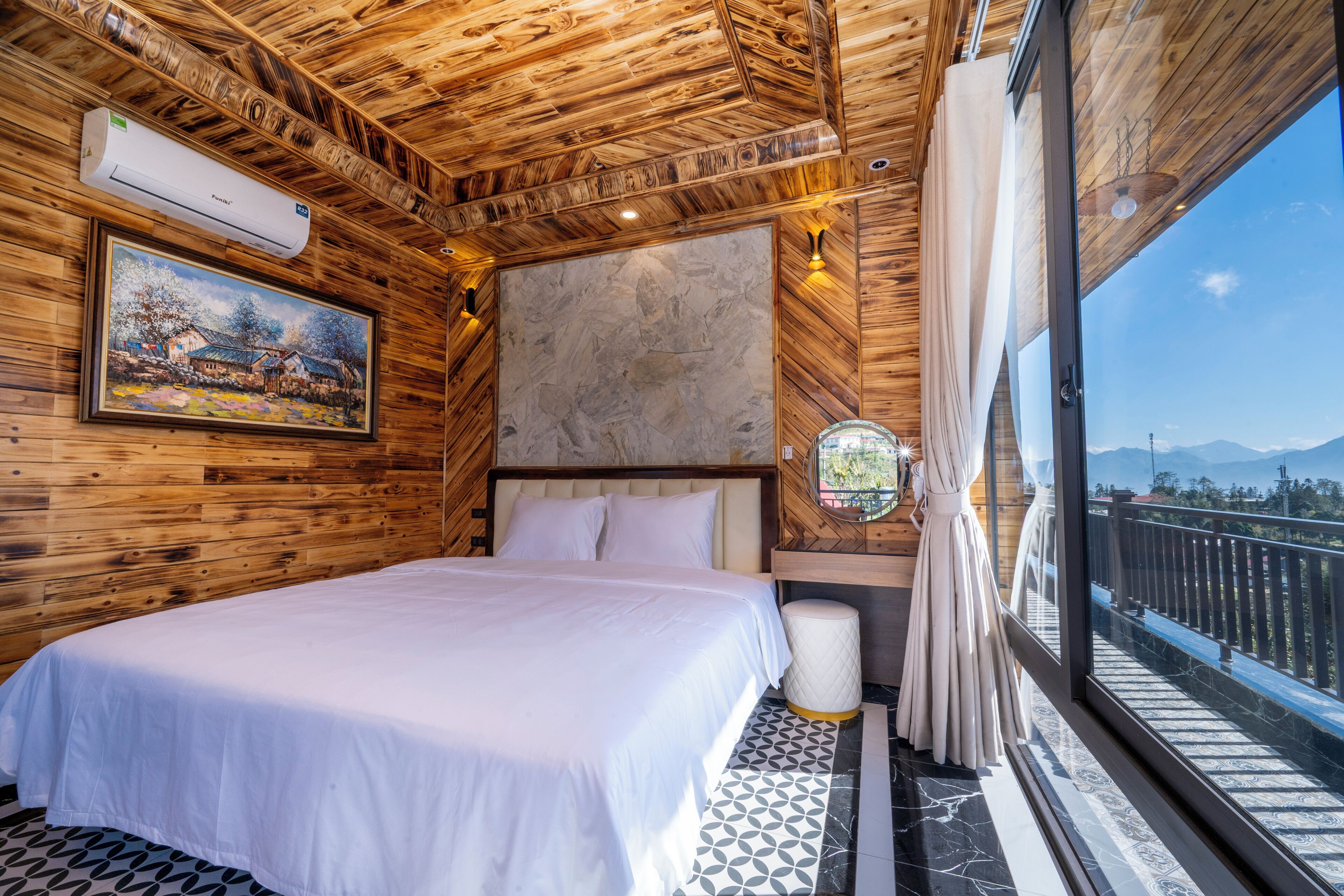 A wooden-paneled room with a bed, a painting, a window with a view, and a marble-patterned floor.
