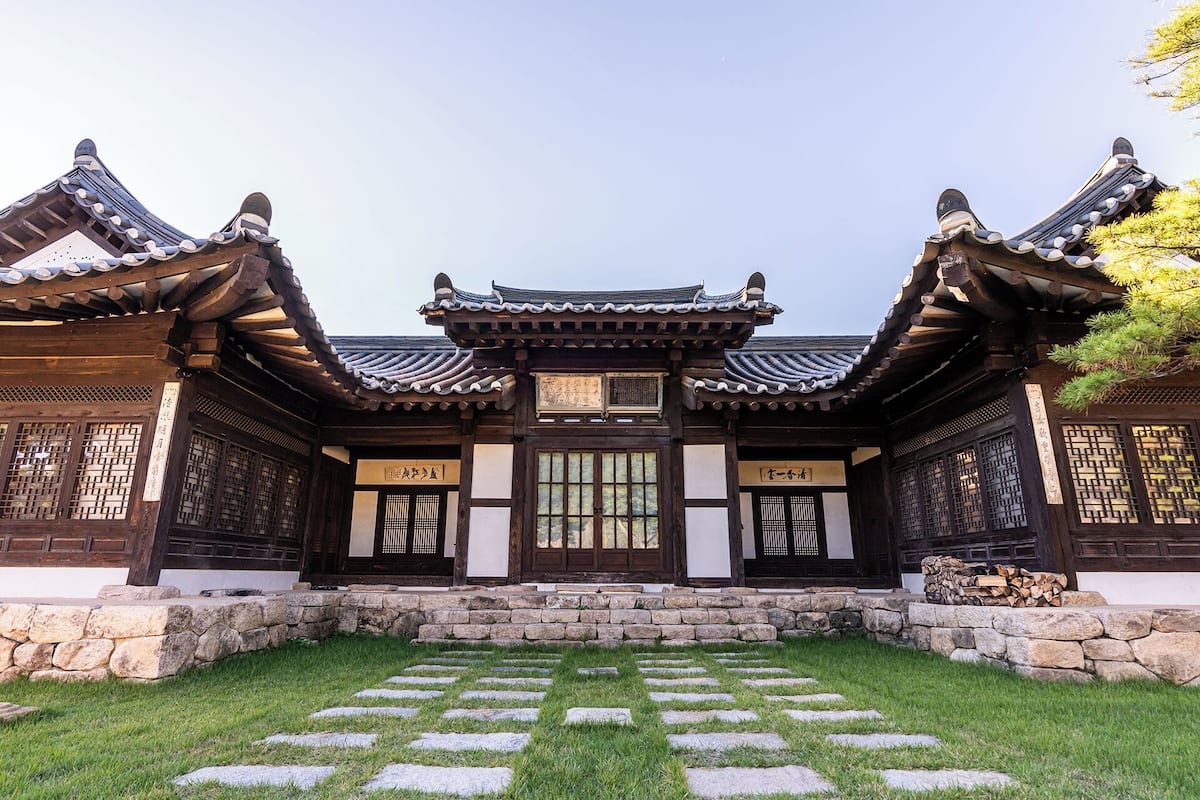 A traditional Korean building with a stone pathway leading to the entrance.