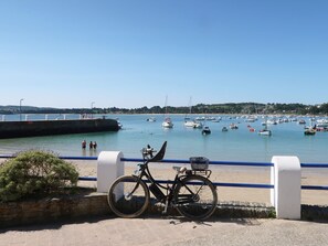 A bicycle parked by a waterfront with a clear view of boats and a distant shoreline. - Ker Soizik by Interhome (Locquirec)