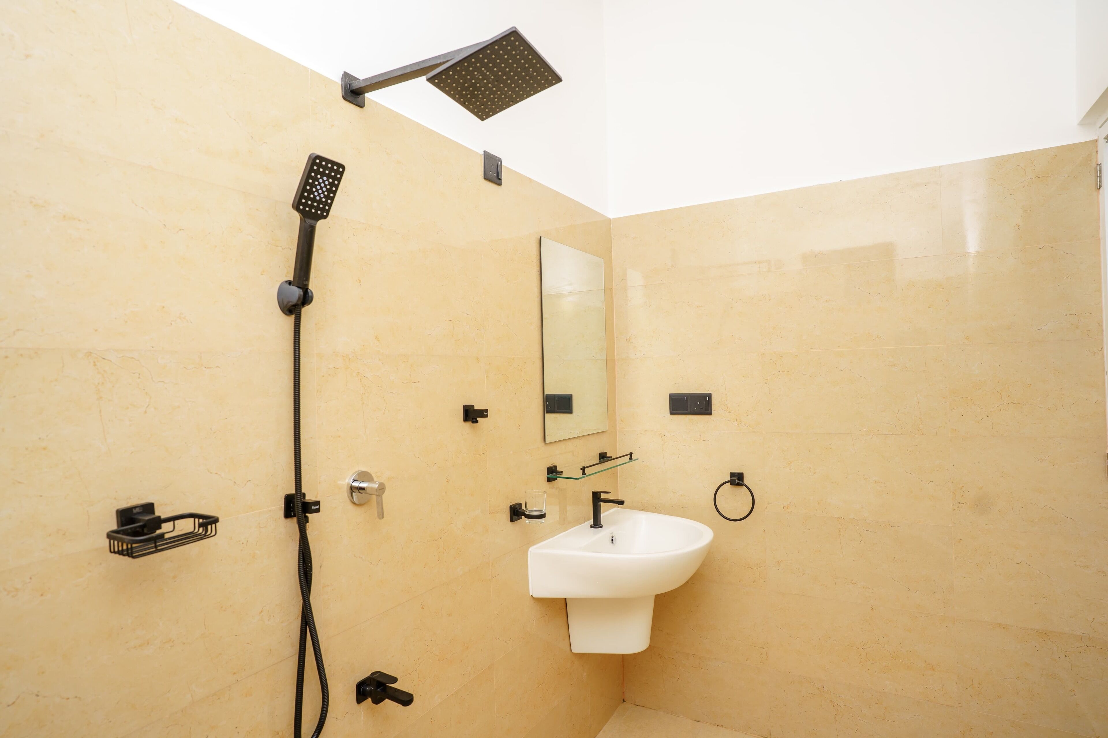 A bathroom with a shower, sink, mirror, and towel rack.