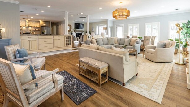 A spacious living area with a large L-shaped sofa, a wooden coffee table, and a patterned rug. - Upscale Family Home Near Downtown Annapolis w Resort-Style Outdoor Spaces (Annapolis)