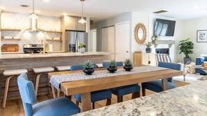 A modern kitchen with a central island, stainless steel appliances, and pendant lighting. - Upscale Family Home Near Downtown Annapolis w Resort-Style Outdoor Spaces (Annapolis)