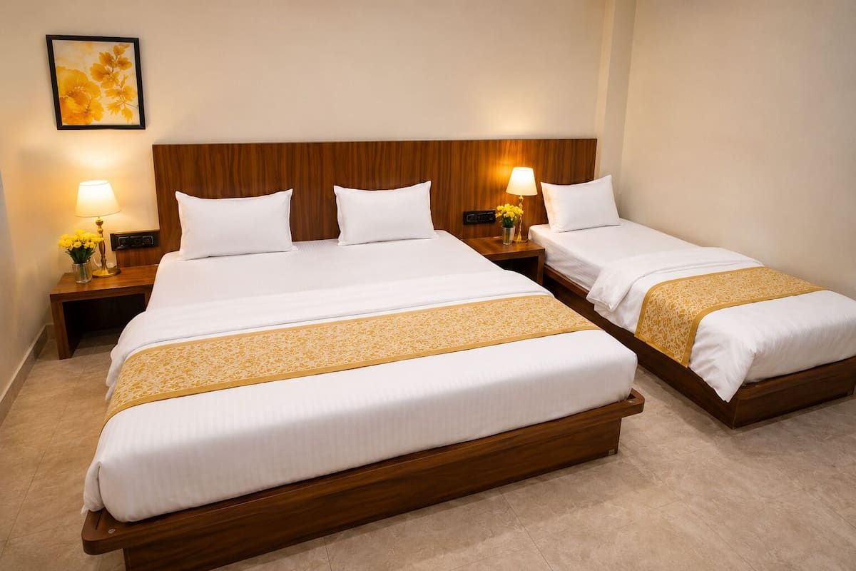 A hotel room with two beds, wooden headboards, bedside lamps, and a decorative wall piece.