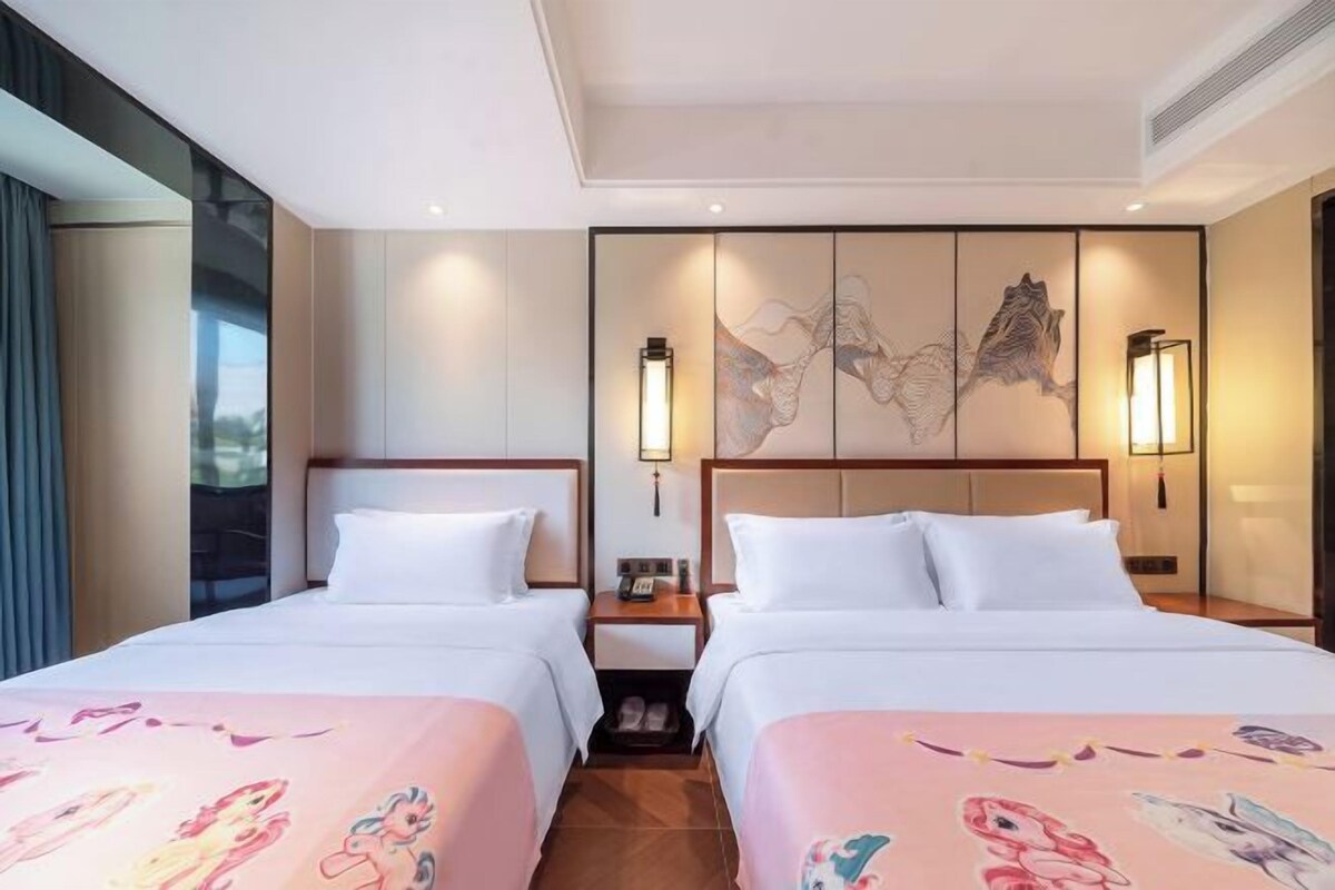 A hotel room with two beds, a large artwork on the wall, and a modern design.