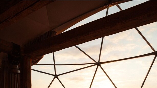 A cozy room with a large window, a bed, and a table with a chair. - Magic rum luxury camp (Wadi rum)