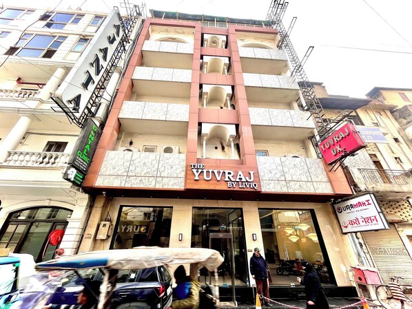 A multi-story building with a prominent sign for 'Yuvraj by Liviq'. - The Yuvraj By LIVIQ (New Delhi)