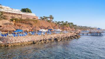 On the beach, sun-loungers, beach umbrellas, beach towels