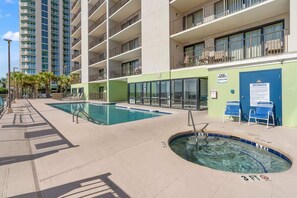 A hotel pool area with two pools, a hot tub, and a lounge area with chairs. - Beach Lover's Retreat 3BR North Myrtle Beach Gem (North Myrtle Beach)